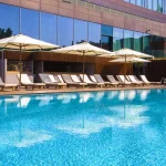 Enjoy the exclusive Pool Club, featuring a serene outdoor pool and spacious sun deck