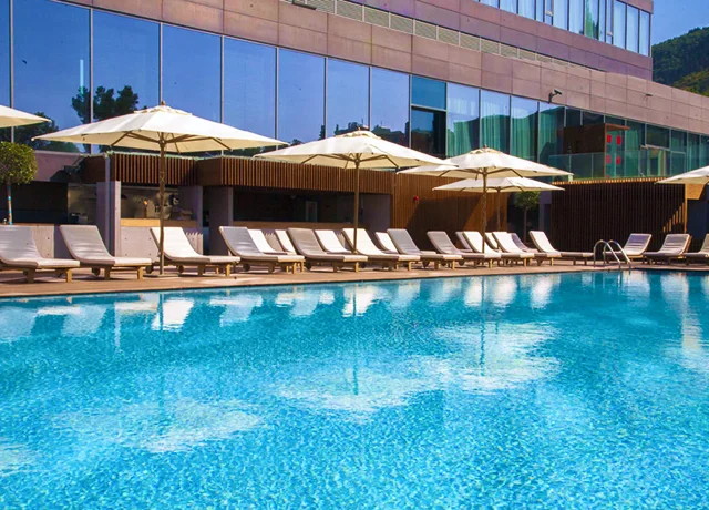 Enjoy the exclusive Pool Club, featuring a serene outdoor pool and spacious sun deck